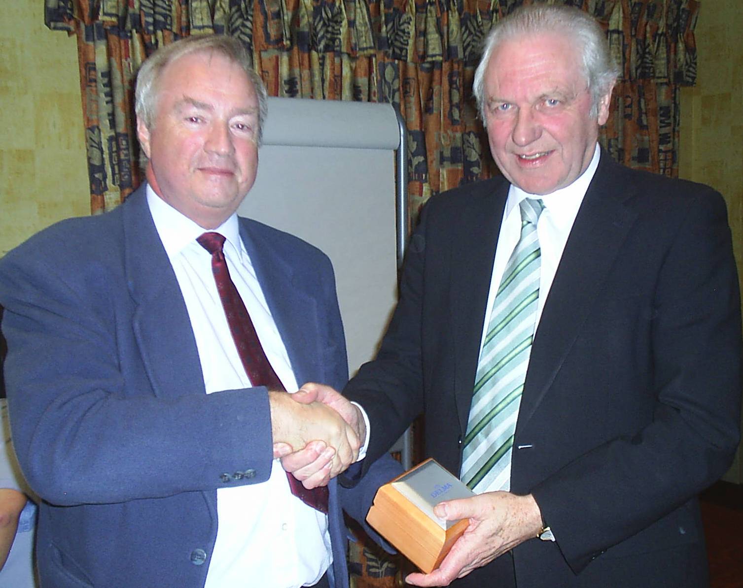 Jim Shaw receiving a watch from Robert Haworth 